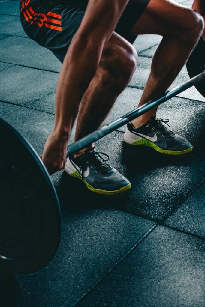 Man performing a deadlift exercise in a gym, demonstrating strength and fitness.